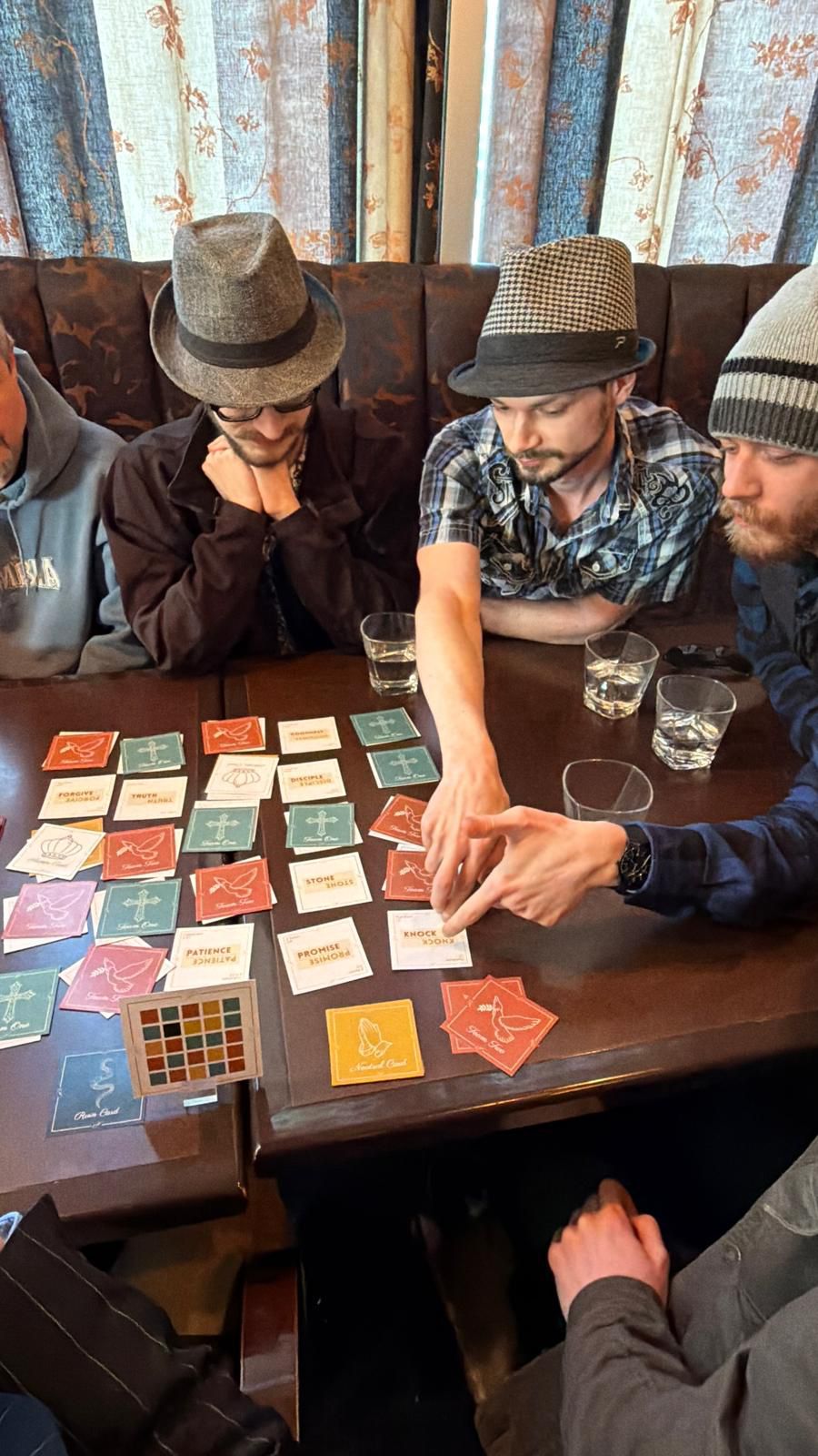 Players concentrating over the Revival card grid
